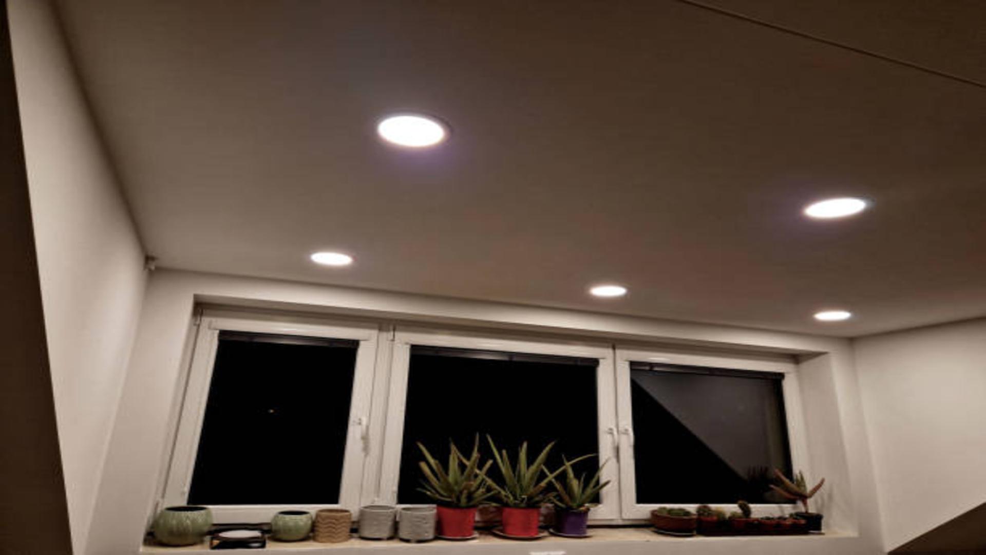 A modern living room with sleek, integrated LED downlights.